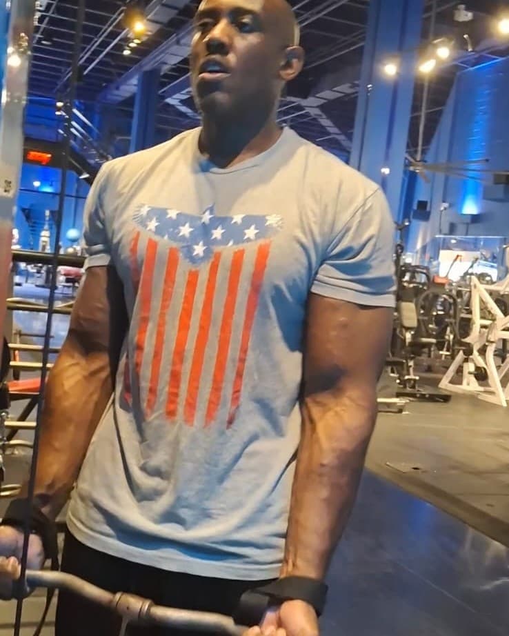 Coach Len training on the cable machine at the gym