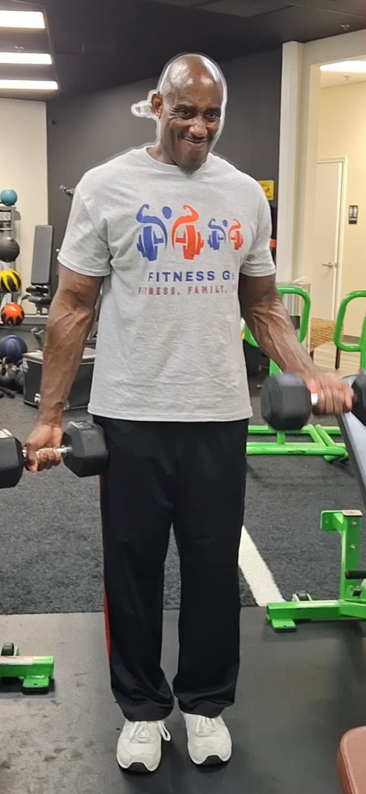 Coach Len training with dumbbells in the gym
